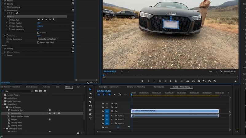 Premiere Pro Program Monitor displaying the front grill of a black Audi car with a four-point polygon blur mask covering the license plate to hide identifying details.