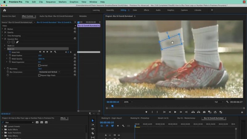 Premiere Pro interface zoomed in to 200 percent on a runner's legs, displaying a rotated rectangular Gaussian Blur mask hiding a brand logo on the white athletic sock.