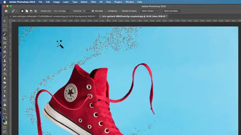 Magic wand tool selecting blue background of image in Photoshop