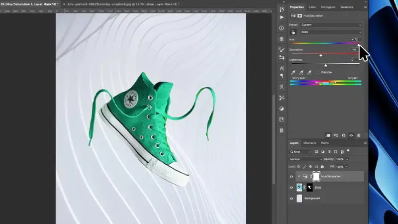 Green shoe on white background with curvy lines