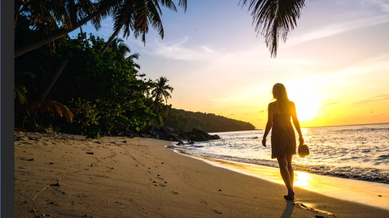 photo of woman walking on a sunset beach in illustrator