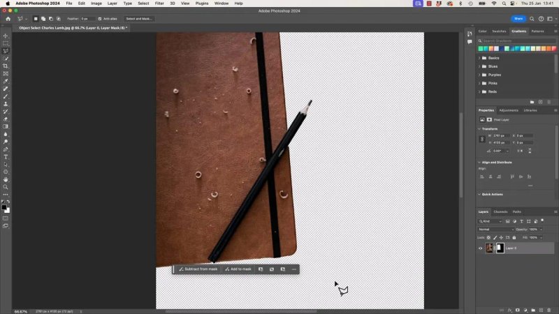 Photoshop workspace displaying the masked leather notebook and pencil cleanly cut out on a transparent grid, with a contextual taskbar offering 