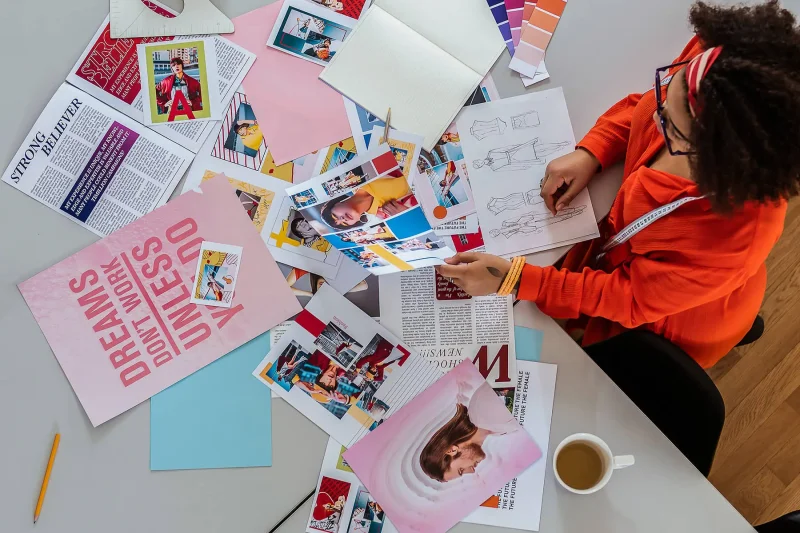 View from above of a colorful selection of design inspiration scattered across a table.