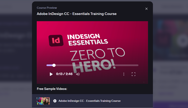 A dark modal popup video player showing a vibrant magenta title card with the InDesign logo and bold white text reading 