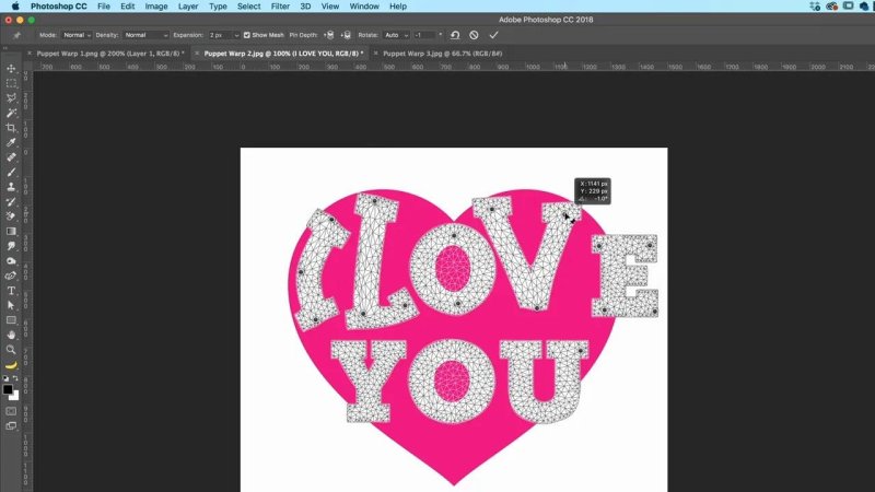 Photoshop interface displaying the text I LOVE YOU placed over a large pink heart, covered with a dense triangular Puppet Warp mesh with a pin rotating the letter E.