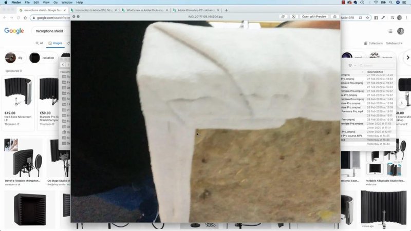 Close-up photo showing acoustic padding along the side of a recording desk setup.