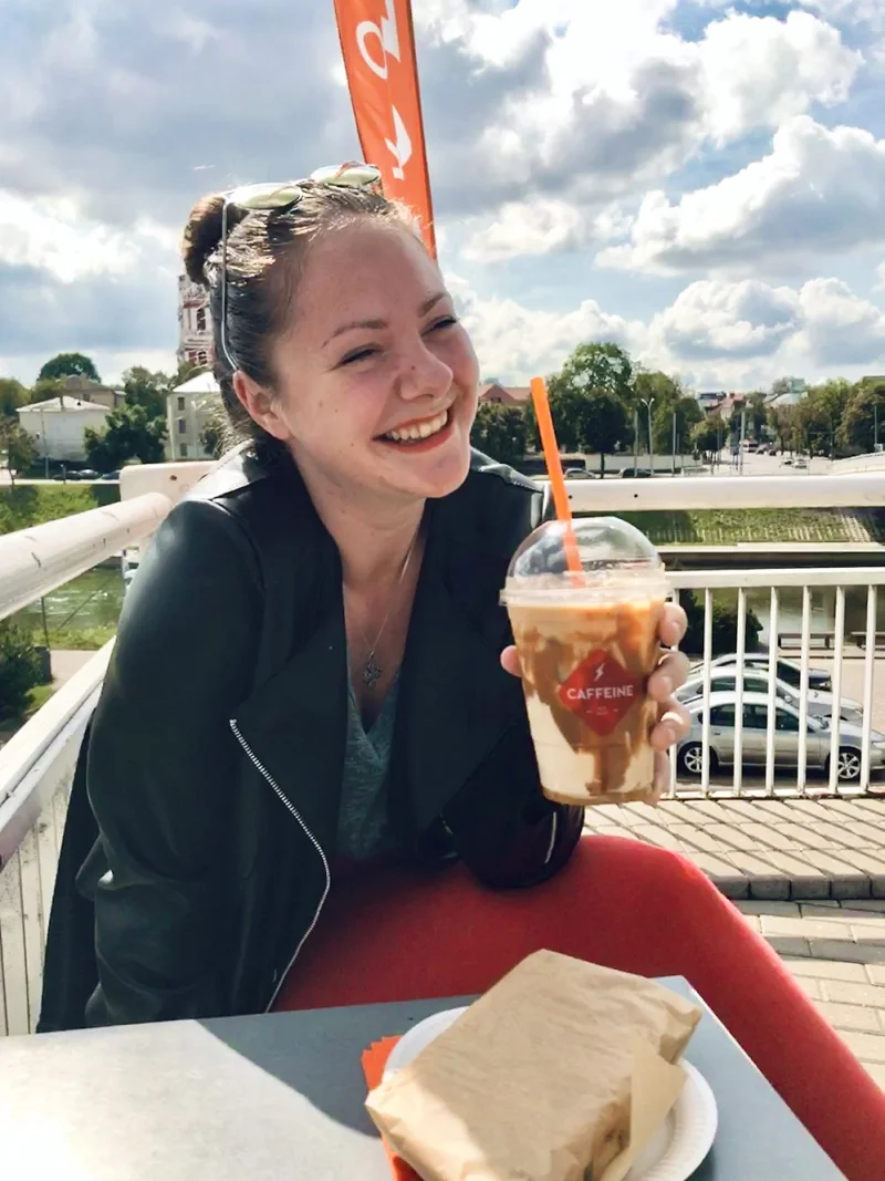 Kotryna Siugzdinyte smiles while holding a beverage in a plastic cup