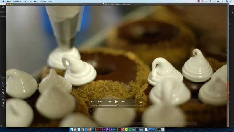 QuickTime Player playing back a close-up B-roll clip of meringue frosting being piped onto chocolate pastries.